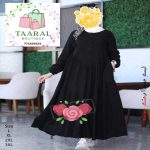 Femme portant une robe longue et ample à manches longues avec col boutonné, de la boutique Taaral Boutique.